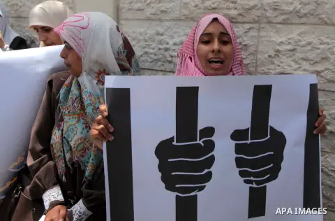 Palestinian youths take part a protest during a rally in Gaza City on May 21, 2014 to express solidarity with Palestinian prisoners on hunger strike in Israeli jails. In late March, Israel had refused to release as promi...
