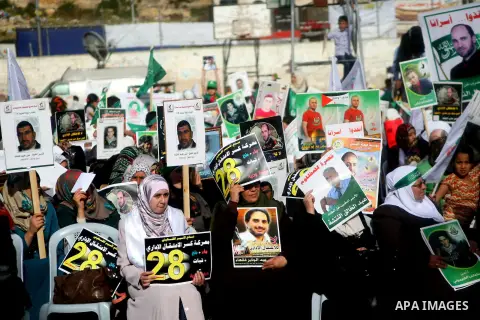 Palestinians take part a protest during a rally to express solidarity with Palestinian prisoners on hunger strike in Israeli jails, in the West Back city of Hebron on May 21, 2014. In late March, Israel had refused to re...