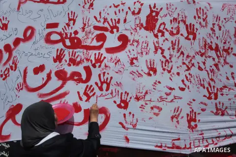 Palestinians lay hands imprint as they tape part a protest in Gaza City on May 22, 2014 to express solidarity with Palestinian prisoners on hunger strike in Israeli jails. In late March, Israel had refused to release as...