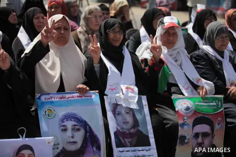 Palestinians take part a protest during a rally in Gaza City on May 22, 2014 to express solidarity with Palestinian prisoners on hunger strike in Israeli jails. In late March, Israel had refused to release as promised a...