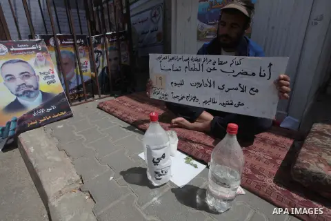Palestinians take part a protest during a rally in Gaza City on May 22, 2014 to express solidarity with Palestinian prisoners on hunger strike in Israeli jails. In late March, Israel had refused to release as promised a...