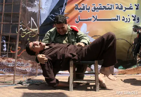 Palestinians men dressed in Israeli soldiers and prisoners uniforms are seen during a performance scene in a protest to express solidarity with Palestinian prisoners on hunger strike in Israeli jails, in Khan Younis in t...