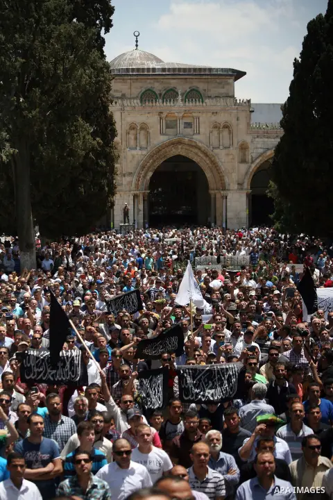 Palestinian supporters of Hizbut Tahrir, a conservative Islamic group shouts slogans during a rally to mark the 93rd anniversary of the overthrow of the Islamic Caliphate, following Friday prayer at al-Aqsa mosque compou...