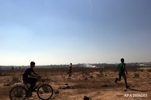 Protesters run as a handmade rocket falls in the Israeli border side during a protest to show solidarity with Palestinian prisoners held in Israeli jails