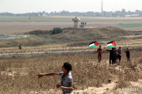 Palestinian protesters wave their national flags during a protest to show solidarity with Palestinian prisoners held in Israeli jails