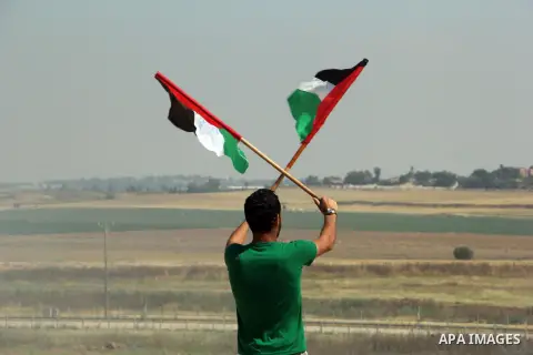 A Palestinian protester waves his national flags during a protest to show solidarity with Palestinian prisoners held in Israeli jails