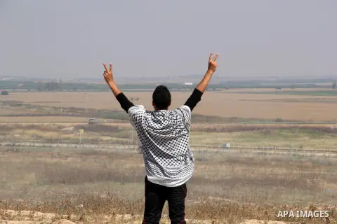 A Palestinian protester flashes victory sign during a protest to show solidarity with Palestinian prisoners held in Israeli jails