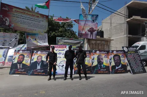 Palestinian policemen stand guard during a protest to solidarity with Palestinian prisoners held in Israeli jails, in front of Red Cross office in Gaza city May 24, 2014. Some 120 Palestinians jailed without trial in Isr...