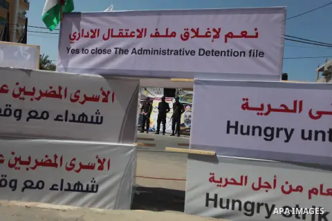 Palestinian policemen stand guard during a protest to solidarity with Palestinian prisoners held in Israeli jails, in front of Red Cross office in Gaza city May 24, 2014. Some 120 Palestinians jailed without trial in Isr...