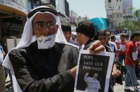 Palestinians take part a protest to solidarity with Palestinian prisoners held in Israeli jails, in the West Bank city of Tulkarem on May 24, 2014. Some 120 Palestinians jailed without trial in Israel have been on an ope...