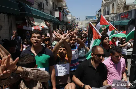 Palestinians take part a protest to solidarity with Palestinian prisoners held in Israeli jails, in the West Bank city of Tulkarem on May 24, 2014. Some 120 Palestinians jailed without trial in Israel have been on an ope...
