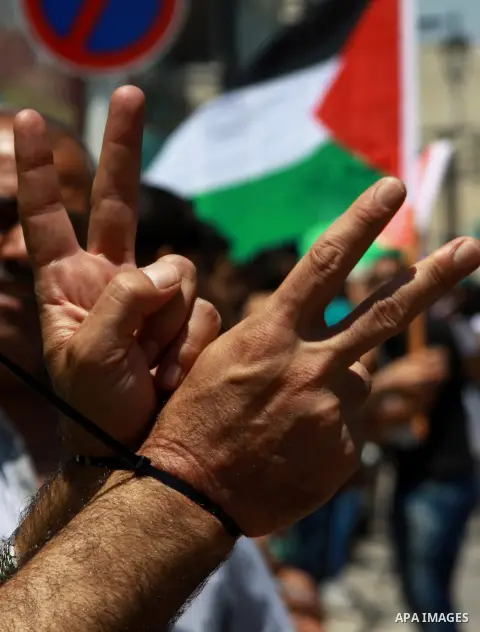 Palestinians take part a protest to solidarity with Palestinian prisoners held in Israeli jails, in the West Bank city of Tulkarem on May 24, 2014. Some 120 Palestinians jailed without trial in Israel have been on an ope...