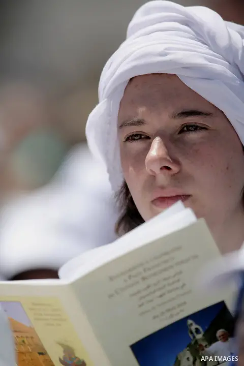 A worshiper attends an open-air mass led by Pope Francis in the Manger Square, next to the Nativity Church in the West Bank town of Bethlehem May 25, 2014. Pope Francis made an impassioned plea for peace on a pilgrimage...