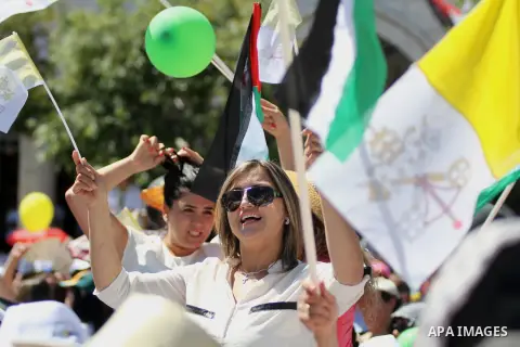 Worshipers attend an open-air mass led by Pope Francis (not pictured), in the Manger Square, next the Nativity Church, in the West Bank city of Bethlehem, 25 May 2014. Pope Francis arrived in the West Bank to start the m...