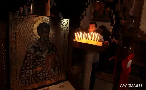 Palestinian Orthodox Christians attend Palm Sunday mass at the Saint Porfirios church in Gaza City May25, 2014. Pope Francis on Sunday invited the Israeli and Palestinian presidents to come to the Vatican to pray for pea...