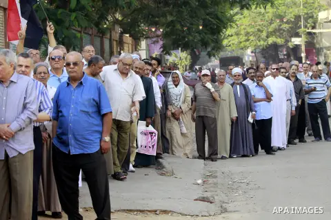 Egyptians queue outside a polling station in Cairo on May 26, 2014. Egyptians begin voting in a new presidential election which ex-army chief Abdel Fattah al-Sisi, who ousted the elected Islamist leader, is expected to e...