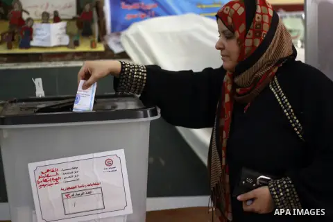A Egyptian woman casts her vote at a polling station in Cairo on May 26, 2014. Egyptians begin voting in a new presidential election which ex-army chief Abdel Fattah al-Sisi, who ousted the elected Islamist leader, is ex...