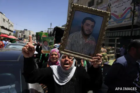 Palestinian supporters of the Hamas movement hold pictures of Palestinian prisoners on hunger strike in Israeli jails during a demonstration in their support in the West Bank city of Ramallah on May 30, 2014. Earlier in...