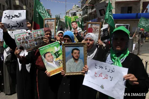 Palestinian supporters of the Hamas movement hold pictures of Palestinian prisoners on hunger strike in Israeli jails during a demonstration in their support in the West Bank city of Ramallah on May 30, 2014. Earlier in...