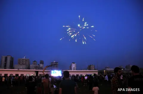 Palestinians celebrate in Gaza City on May 30, 2014, after Palestine qualified for their maiden Asian Cup appearance with a 1-0 win over injury-hit Philippines in the final of the AFC Challenge Cup in Maldives. Photo by...