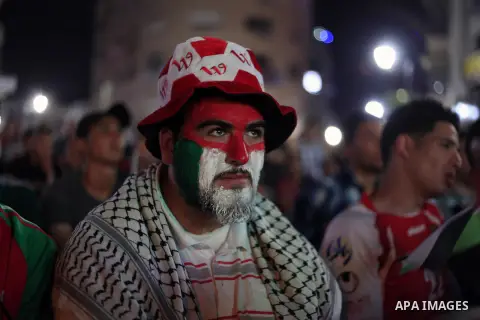 Palestinians watch the match between their national team and the Philippine team during the final of the AFC Challenge Cup in Maldives, in the West Bank city of Ramallah on May 30, 2014. Photo by Issam Rimawi