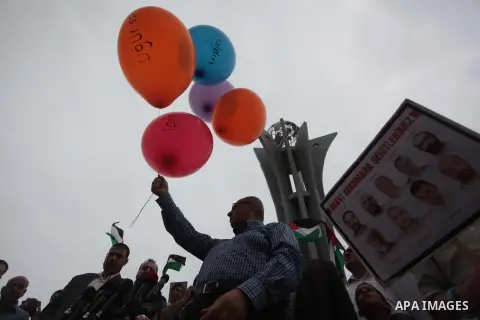 Palestinians hold balloons during a rally on the fourth anniversary of the Mavi Marmara Gaza flotilla incident, at the seaport of Gaza City May 31, 2014. Eight Turks and a Turkish-American, died in an Israeli commando ra...