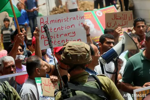 Palestinian Protesters gather to demonstrate in support of Palestinian prisoners on hunger strike in Israeli jails at the al-Aroub Palestinian refugee camp, just north the West Bank town of Hebron on May 31, 2014. Photo...