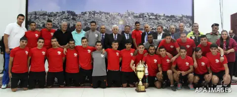 Palestinian President Mahmoud Abbas receives the Palestinian national football team which won the AFC Challenge Cup, at Abbas's office in the West Bank city of Ramallah on June 1, 2014. Palestine qualified for their maid...