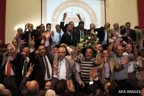 Egyptian journalists and State Information Service (SIS) employees celebrate at the end of a press conference in the capital Cairo on June 3, 2014, in which the electoral commission announced that Ex-army chief Abdel Fat...