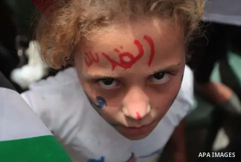 Palestinian children take part in a summer camp organized by Hamas on June 4, 2014. Thousands of elementary school students in the Gaza Strip are going to Hamas summer camps, in which they take part in recreational activ...