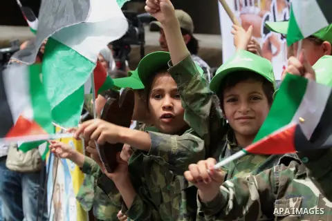Palestinian children take part in a summer camp organized by Hamas on June 4, 2014. Thousands of elementary school students in the Gaza Strip are going to Hamas summer camps, in which they take part in recreational activ...