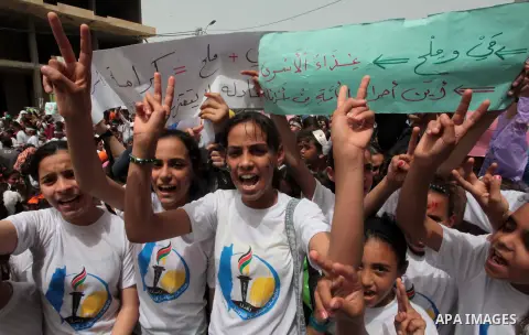 Palestinians take part a protest to solidarity with Palestinian prisoners held in Israeli jails, in Gaza city June 04, 2014. About 120 Palestinians imprisoned without trial in Israel on an open hunger strike, and only sa...