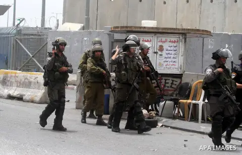 Israeli soldiers and border police take position as Palestinians protest in solidarity with prisoners on hunger strike, at Qalandia checkpoint near the West Bank city of Ramallah June 5, 2014. Some 120 Palestinians jaile...