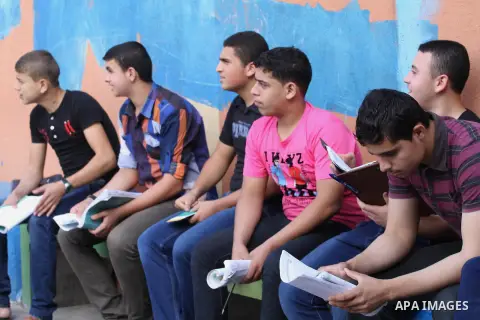 Palestinian students Wait for their final high school exams, known as "Tawjihi", in Gaza City on June 7, 2014. About 85 thousand students in the Gaza Strip and the West Bank to provide the High school exams. Photo by Moh...