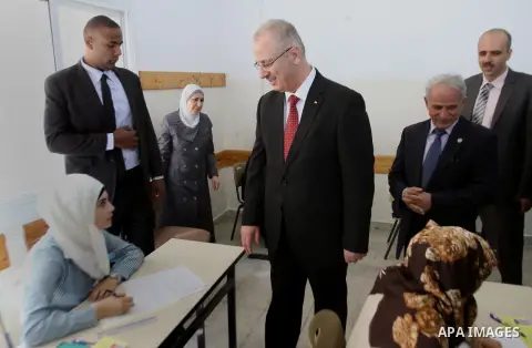 Palestinian Prime Minister Rami Hamdallah visits a school during the first day of high school exams, or (Tawjihe) in the West Bank city of Nablus, 07 June 2014. More than 85,000 high school students from the West Bank, i...