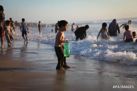 Palestinians children enjoy a summer day at the beach in Gaza city, on June 6, 2014. Friday is the Muslim holiday and as summer is entering many Palestinian people go to the beach since it is the major entertainment area...