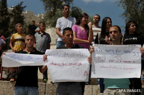 Palestinians take part in a rally in solidarity with prisoners on hunger strike, in Jerusalem's Old City on June 7, 2014. Some 120 Palestinians jailed without trial in Israel have been on an open-ended hunger strike, eat...