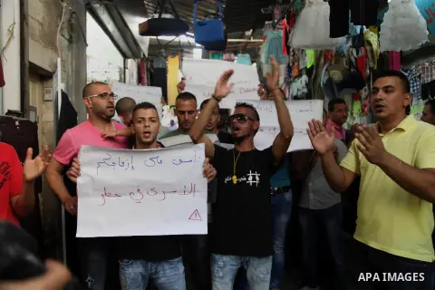 Palestinians take part in a rally in solidarity with prisoners on hunger strike, in Jerusalem's Old City on June 7, 2014. Some 120 Palestinians jailed without trial in Israel have been on an open-ended hunger strike, eat...