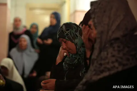 Palestinian relatives of fisherman Imad Salem mourn in his house during his funeral in Beit Lahiya town in the northern Gaza Strip, 08 June 2014. Salem, 51, who was injured two weeks earlier when Israeli navy fired at th...