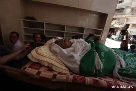 Palestinian relatives of fisherman Imad Salem mourn over the body during his funeral in Beit Lahiya town in the northern Gaza Strip, 08 June 2014. Salem, 51, who was injured two weeks earlier when Israeli navy fired at t...