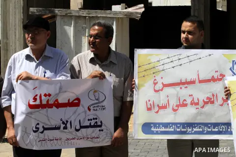 Palestinian journalists and media members take part in a demonstration in support of Palestinian prisoners on hunger strike in Israeli jails, outside Red Cross office, in Gaza City on June 8, 2014. U.N. Secretary-General...