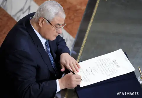 A handout picture made available on June 8, 2014 by the Egyptian presidency shows outgoing interim president Adly Mansour signing the handing over of power document from in Cairo. Former army chief Abdel Fattah al-Sisi w...