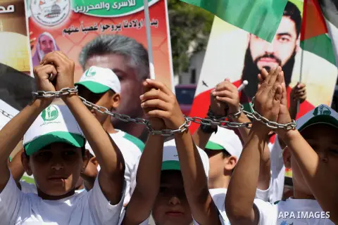 Palestinian children take part in a summer camp organized by Hamas on June 9, 2014. Thousands of elementary school students in the Gaza Strip are going to Hamas summer camps, in which they take part in recreational activ...