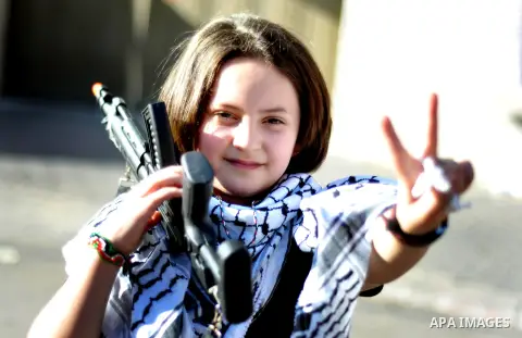 A Palestinian girl flashes victory sign during a demonstration in support of 125 Palestinian prisoners detained in Israeli jails and who have been on hunger strike for six weeks, outside Red Cross office, in Gaza City on...