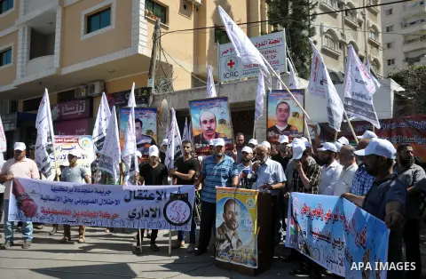 Palestinians take part in a demonstration in support of 125 Palestinian prisoners detained in Israeli jails and who have been on hunger strike for 50 days, outside Red Cross office, in Gaza City on June 11, 2014. 285 Pal...