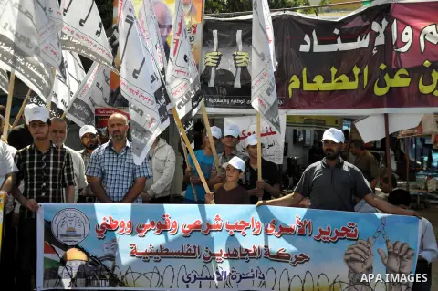 Palestinians take part in a demonstration in support of 125 Palestinian prisoners detained in Israeli jails and who have been on hunger strike for 50 days, outside Red Cross office, in Gaza City on June 11, 2014. 285 Pal...