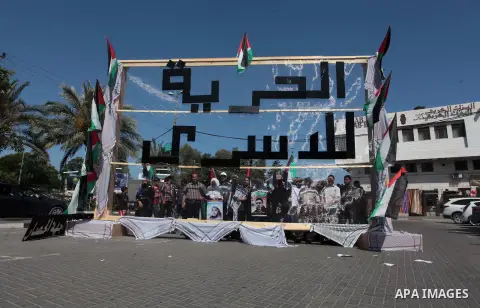 Members of the Palestinian popular committee against the siege take part in a demonstration to support of 125 Palestinian prisoners detained in Israeli jails and who have been on hunger strike for 50 days in Gaza City on...