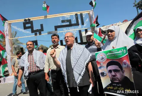Members of the Palestinian popular committee against the siege take part in a demonstration to support of 125 Palestinian prisoners detained in Israeli jails and who have been on hunger strike for 50 days in Gaza City on...