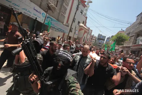 Palestinians carry body the of Mohammed Arour, 30 during his funeral in Beit Lahiya town in the northern Gaza Strip, June 12, 2014. Militants in the Gaza Strip fired a rocket into Israel on Wednesday for the first time s...