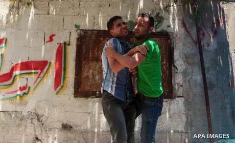 Relatives of Palestinian militant Mohammed Al-Awour mourn during his funeral in Beit Lahiya in the northern Gaza Strip June 12, 2014. Militants in the Gaza Strip fired a rocket into Israel on Wednesday for the first time...